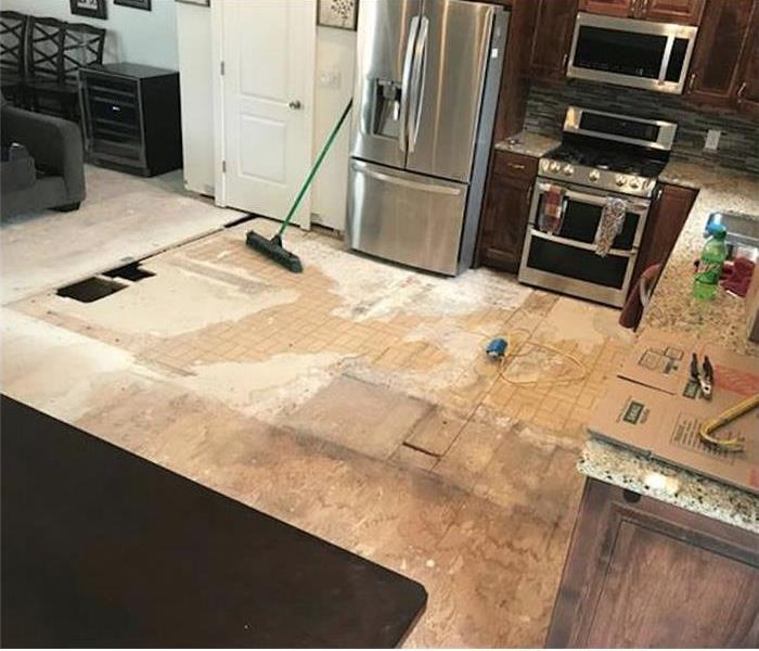 Kitchen walls and floor damaged with water