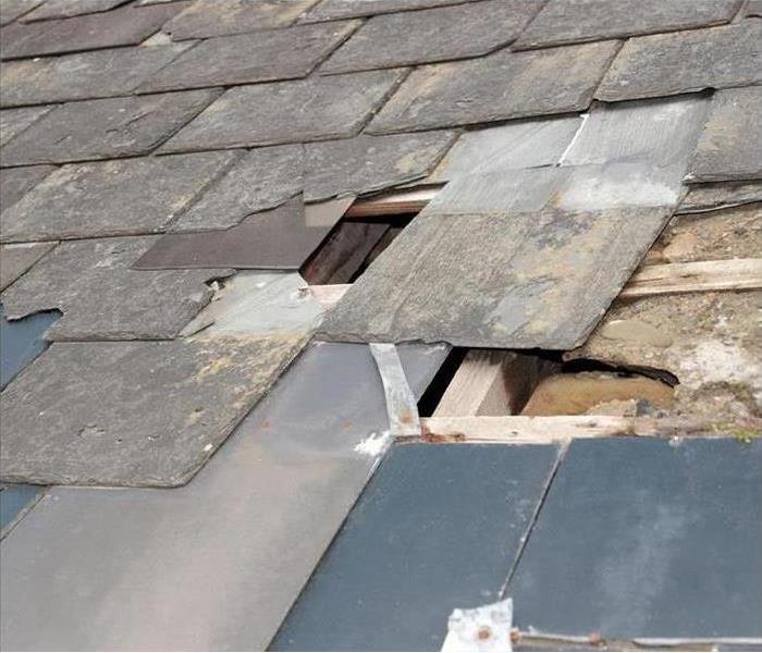 Image of a roof damaged after a storm. 