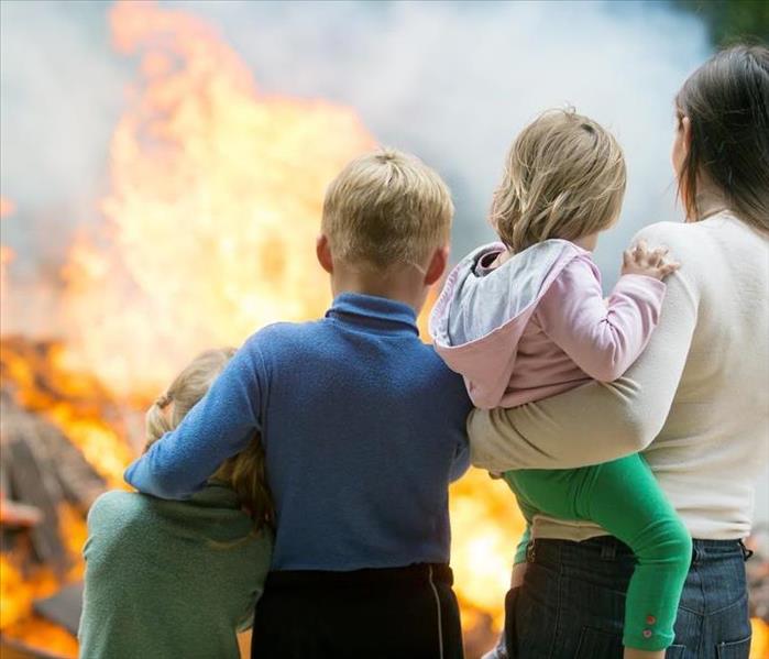 A Family watching their House on Fire.