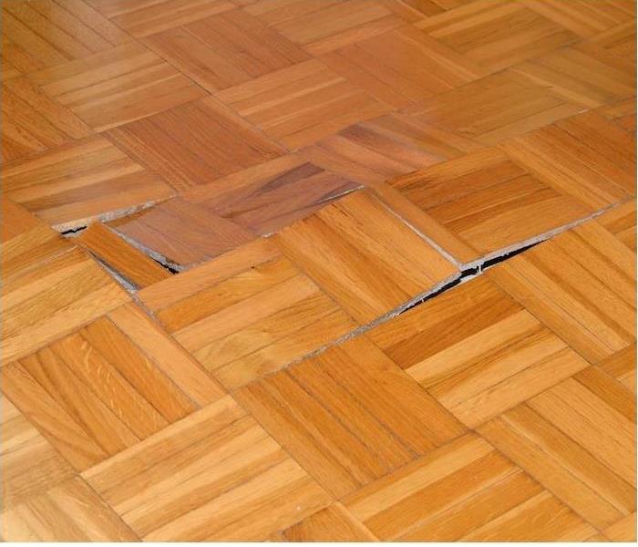 parquet light brown wood flooring popped up from water damage